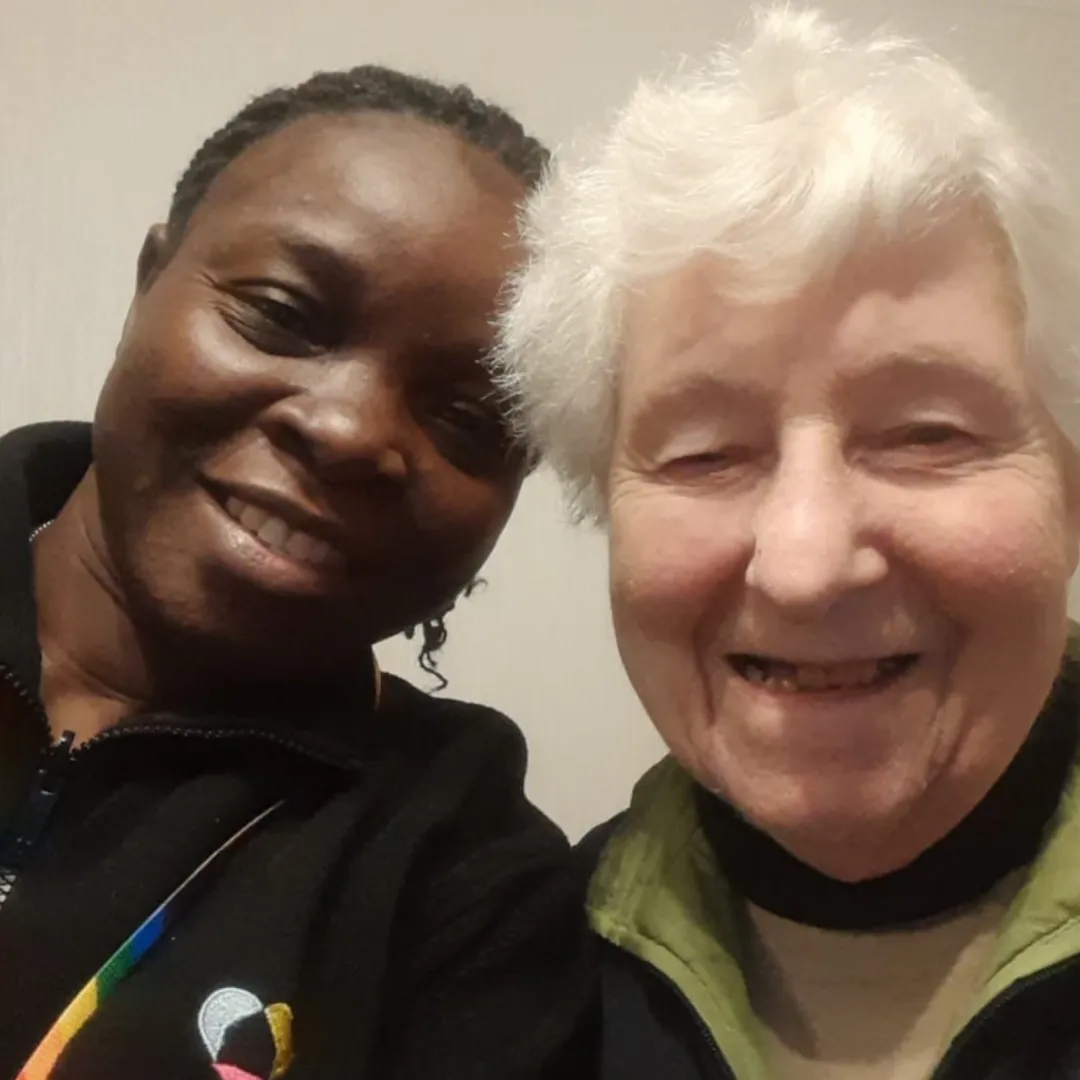 Astar Homecare carers visiting an elderly male client in bed, smiling together for a warm and caring selfie.